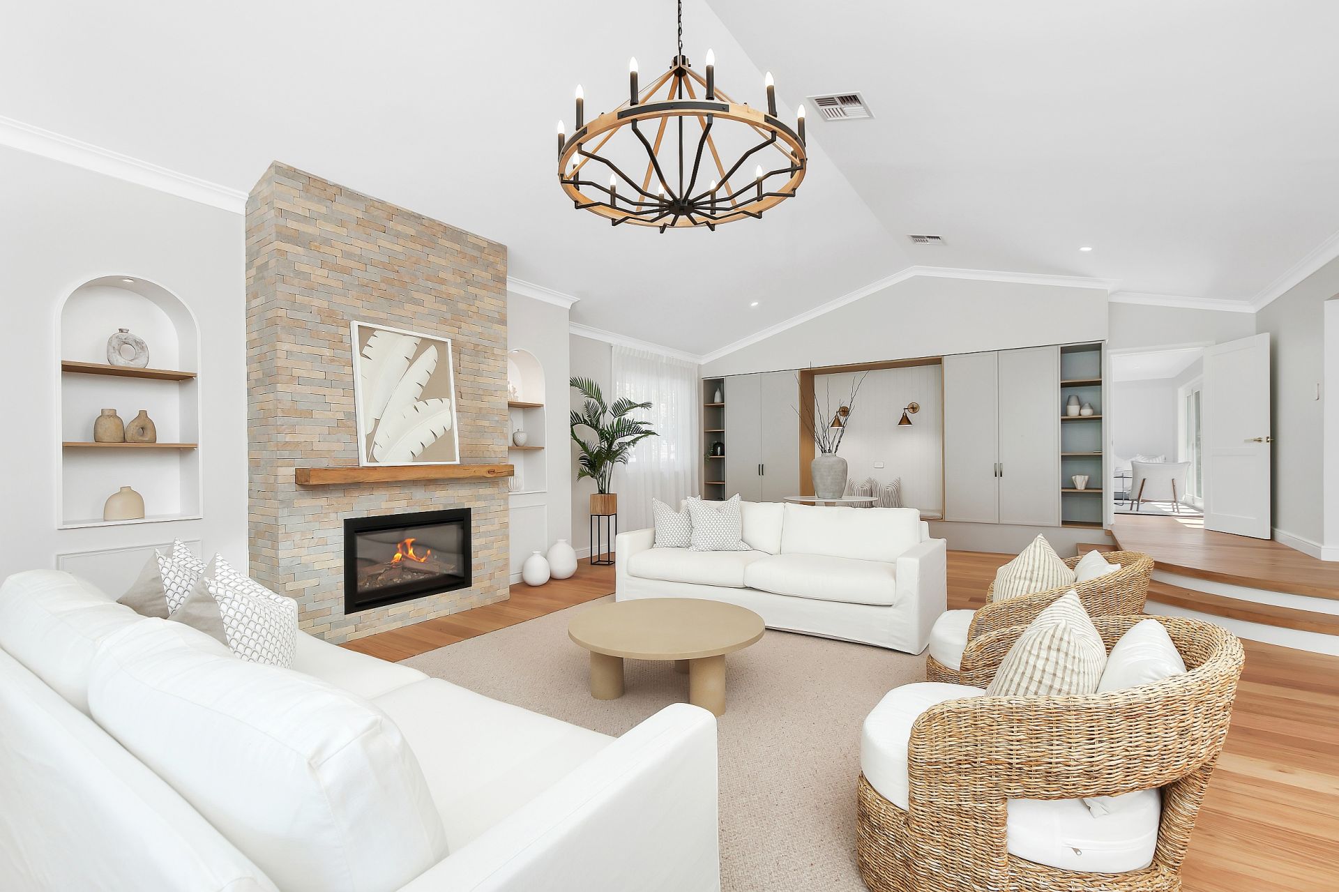Melody Park — lounge room, stone fireplace, linen sofas, warm contemporary country