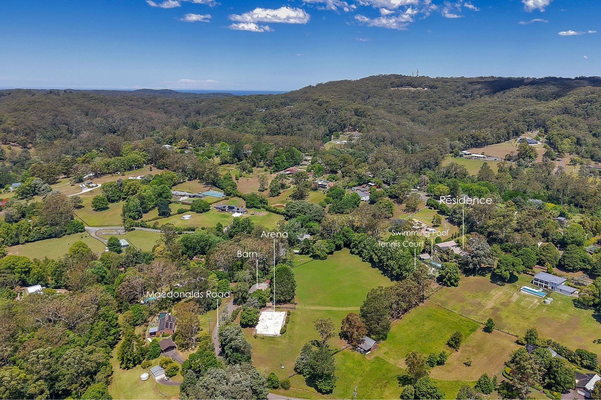 Melody Park — aerial view across 4.57 acres, paddocks, tennis court, pool and the Central Coast hinterland